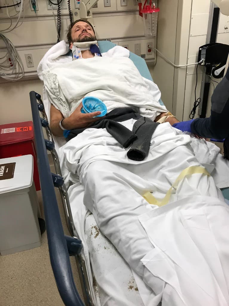 Jake in a hospital trauma bay after his strokes, still in a neck brace